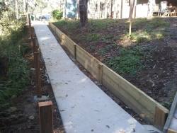 A photo of the Retaining wall beside path that leads to the practice range
